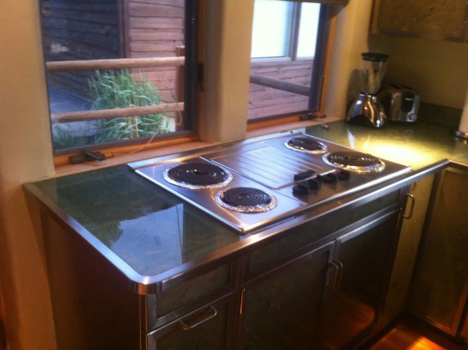 Kitchen - mid-sized transitional u-shaped medium tone wood floor and brown floor kitchen idea with a double-bowl sink, stainless steel appliances and a peninsula