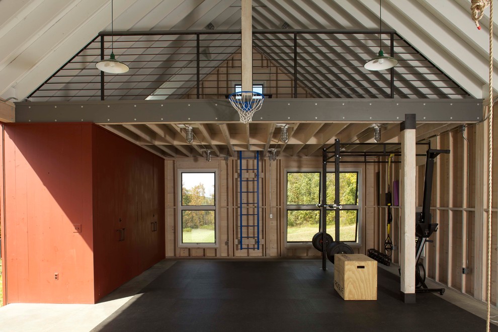 This is an example of an eclectic home gym in New York with concrete floors.