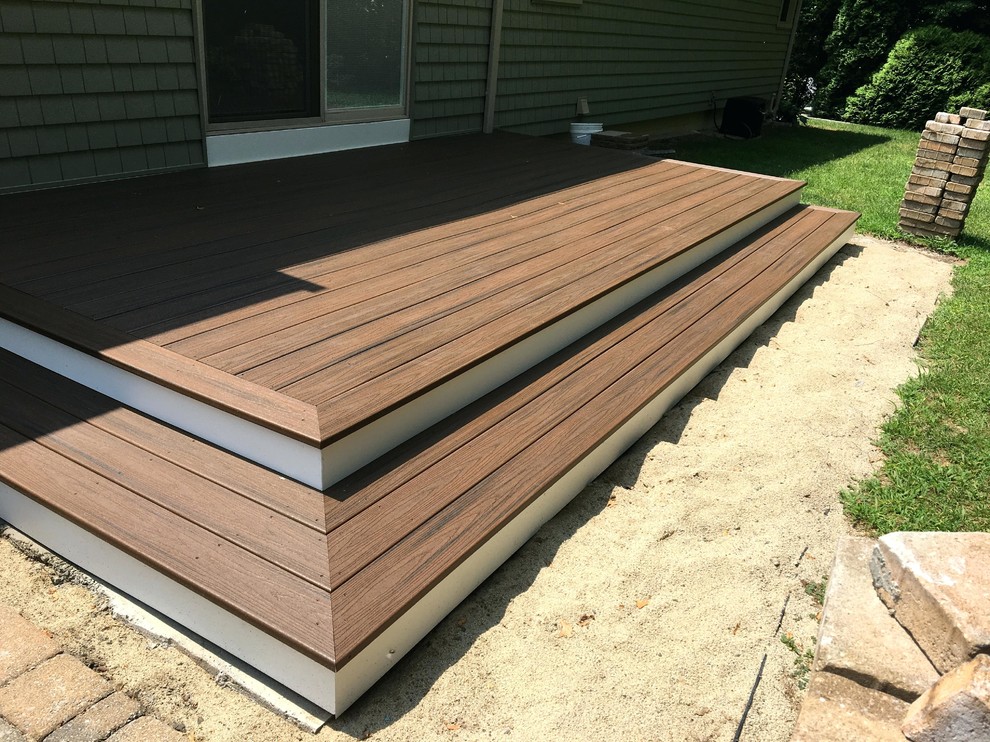 This is an example of a mid-sized contemporary backyard deck in Charlotte with no cover.