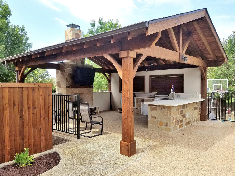 This is an example of a large country backyard patio in Dallas with an outdoor kitchen, concrete slab and a gazebo/cabana.
