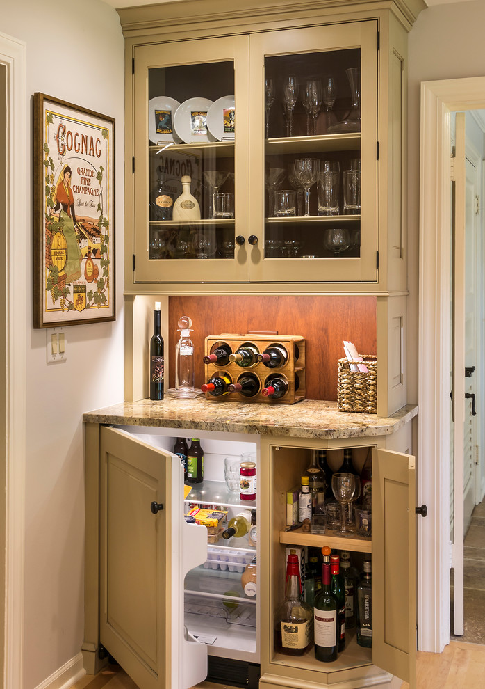 Small country single-wall home bar in Chicago with beige cabinets, granite benchtops, brown splashback and medium hardwood floors.