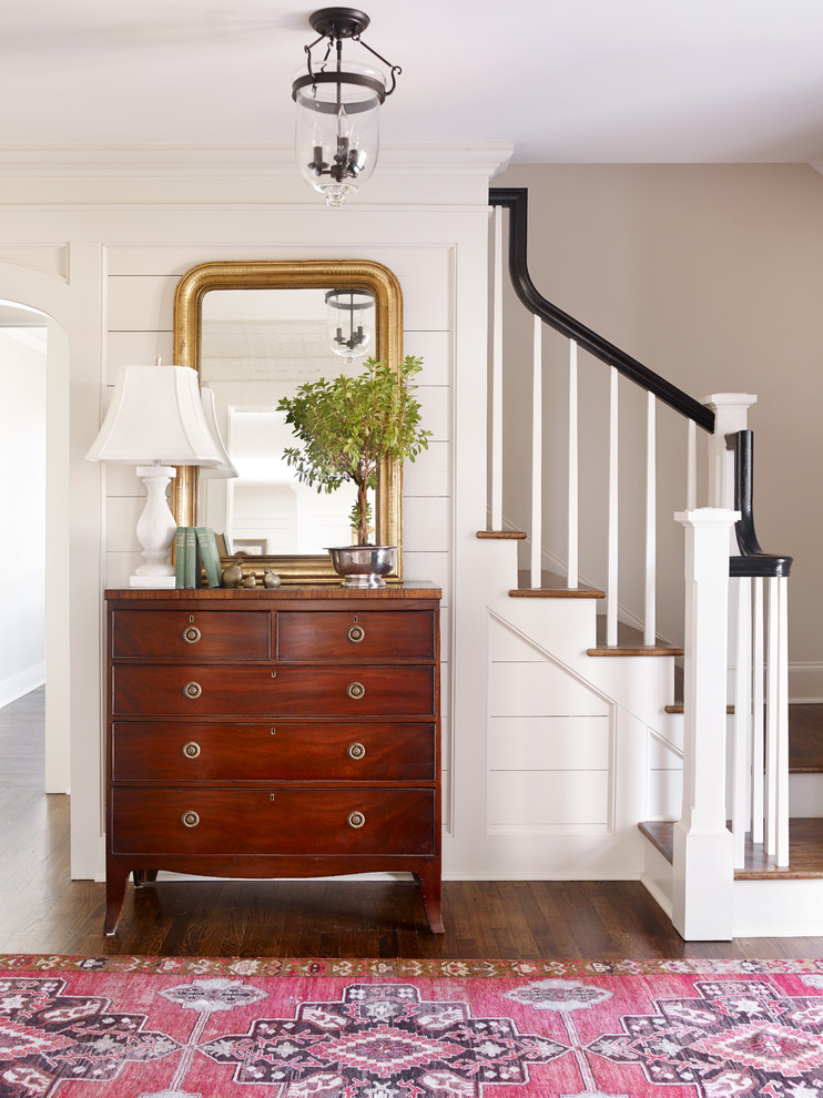 Traditional foyer in Atlanta with white walls and dark hardwood floors.