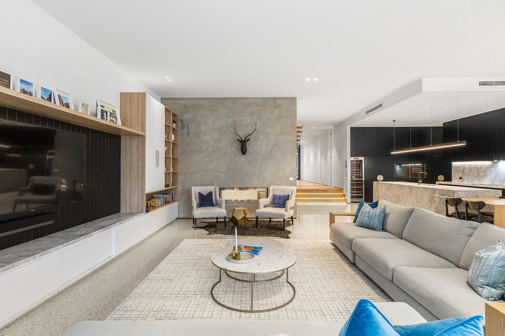 Large contemporary open concept living room in Melbourne with white walls, a built-in media wall, beige floor, concrete floors, a two-sided fireplace and a concrete fireplace surround.