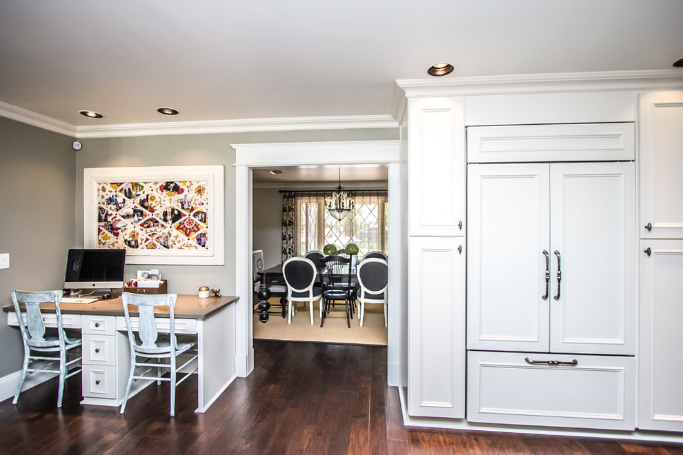Eat-in kitchen - large transitional u-shaped dark wood floor and brown floor eat-in kitchen idea in Phoenix with a double-bowl sink, recessed-panel cabinets, white cabinets, quartzite countertops, white backsplash, ceramic backsplash, paneled appliances and an island
