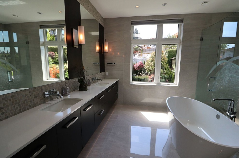 Inspiration for a mid-sized contemporary master bathroom in Vancouver with flat-panel cabinets, black cabinets, a freestanding tub, an alcove shower, porcelain tile, grey walls, porcelain floors, an undermount sink, engineered quartz benchtops, grey floor, a hinged shower door and white benchtops.