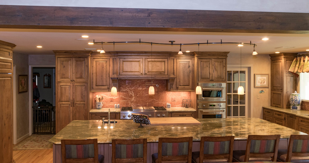 Eat-in kitchen - large rustic u-shaped eat-in kitchen idea with distressed cabinets, granite countertops, stone slab backsplash, stainless steel appliances and an island