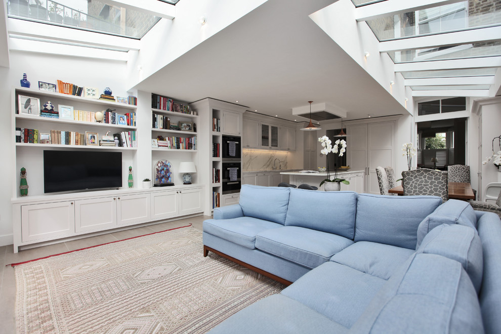 Photo of an open concept living room in London with a built-in media wall.