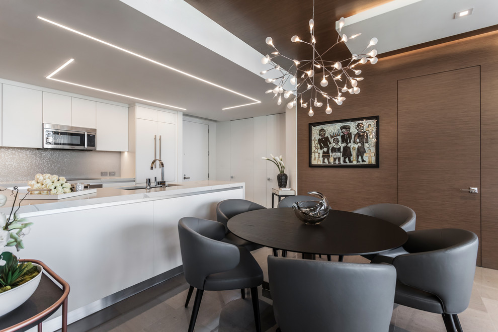 This is an example of a contemporary kitchen/dining combo in Miami with brown walls, no fireplace and grey floor.