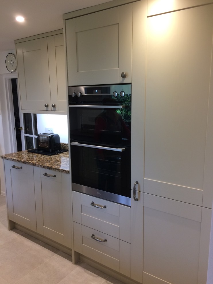 Design ideas for a country kitchen in Kent with shaker cabinets, granite benchtops and multi-coloured benchtop.