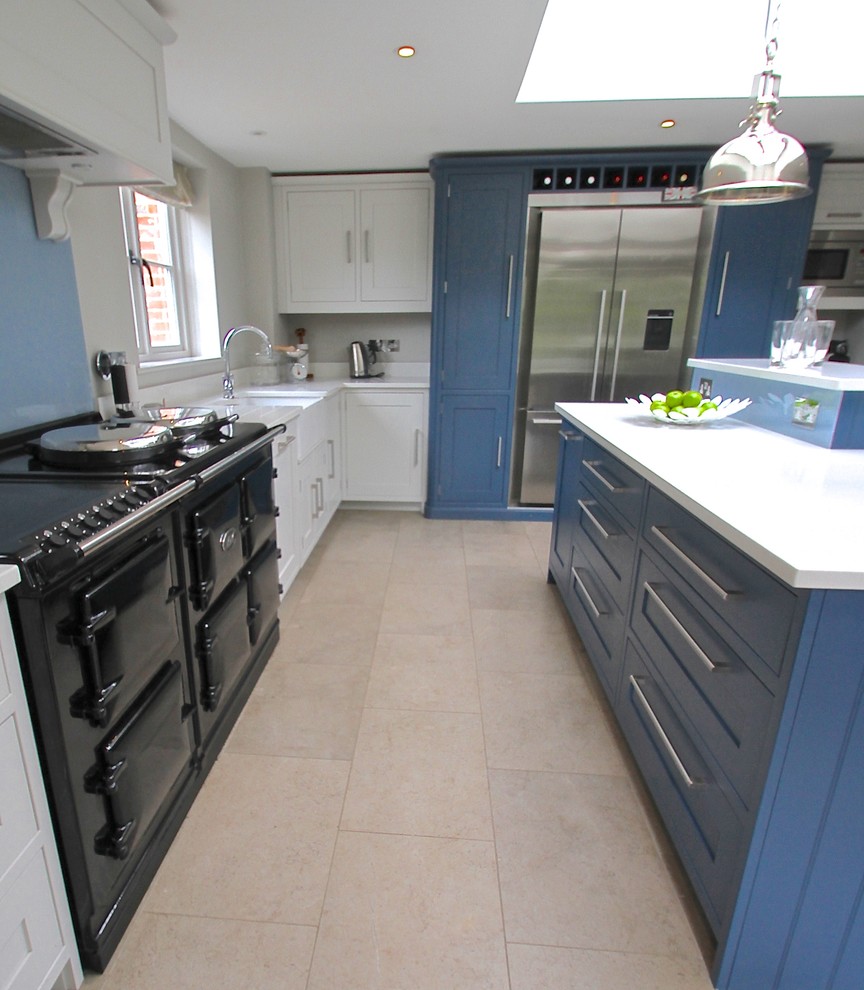 Inspiration for a large country l-shaped eat-in kitchen in Berkshire with a farmhouse sink, shaker cabinets, blue cabinets, quartzite benchtops, blue splashback, glass sheet splashback, stainless steel appliances, limestone floors and with island.