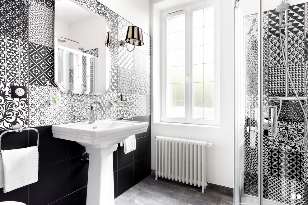 Photo of a transitional master bathroom in Paris with black and white tile, a pedestal sink, a curbless shower, mosaic tile and white walls.