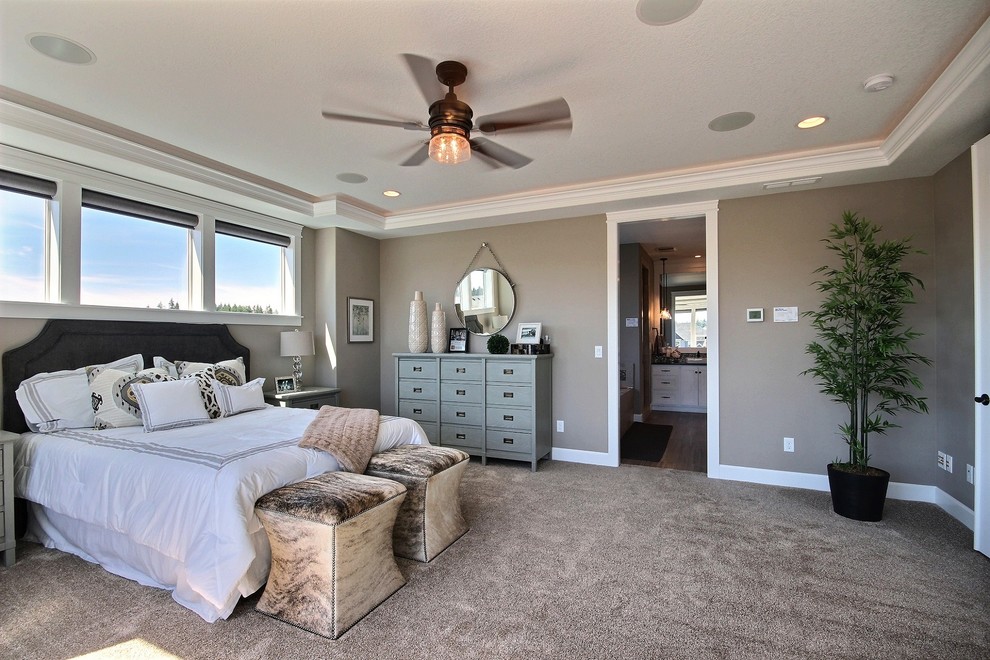 Inspiration for an expansive transitional master bedroom in Portland with beige walls and carpet.