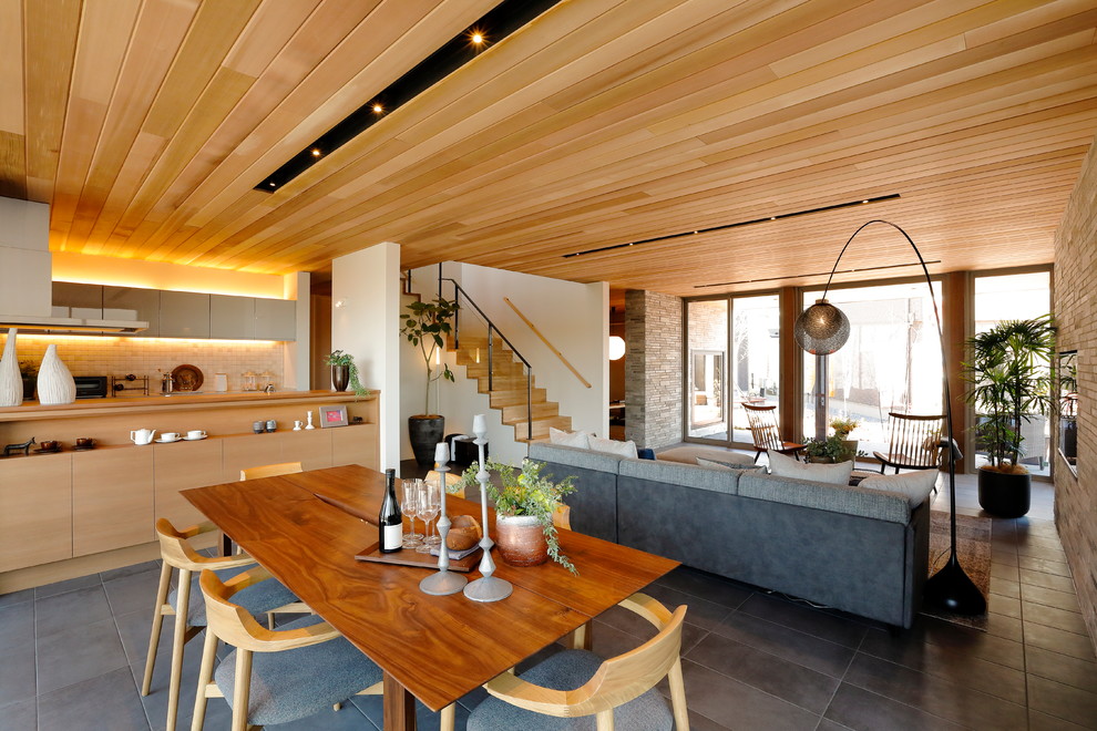 This is an example of a modern open plan dining in Other with multi-coloured walls and grey floor.