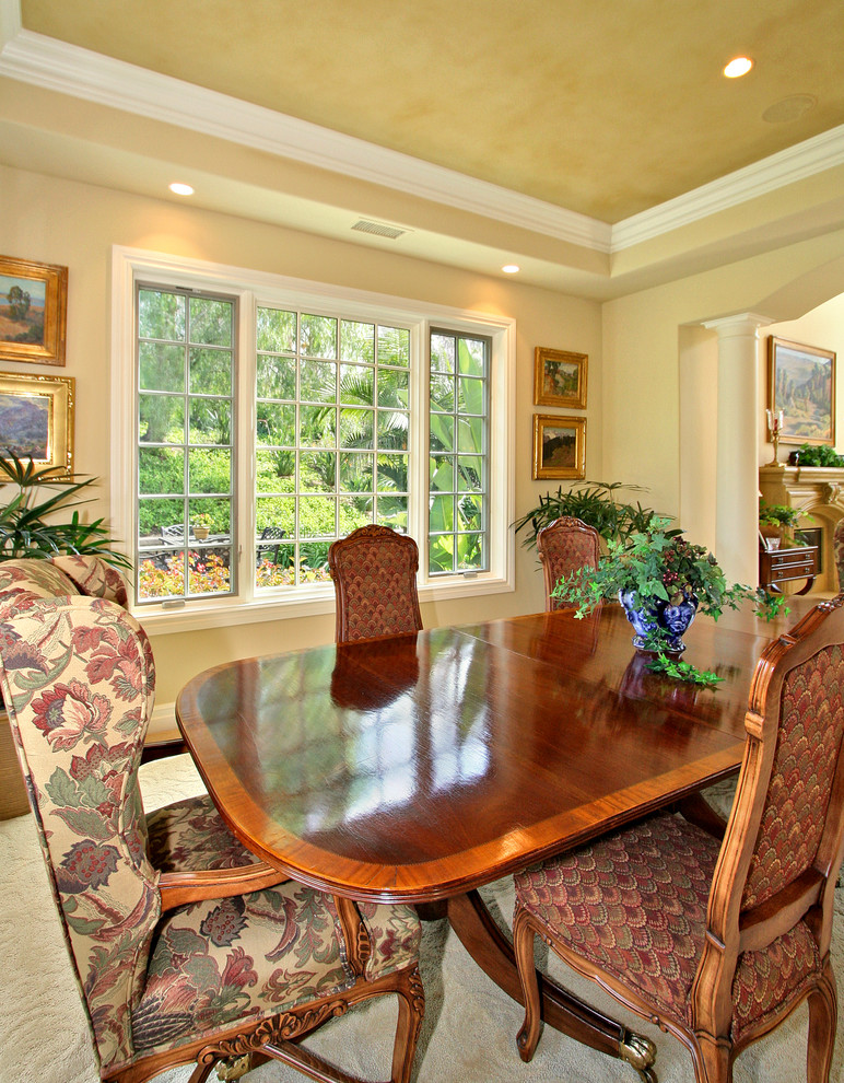 Inspiration for a mid-sized traditional separate dining room in San Diego with beige walls, carpet and no fireplace.