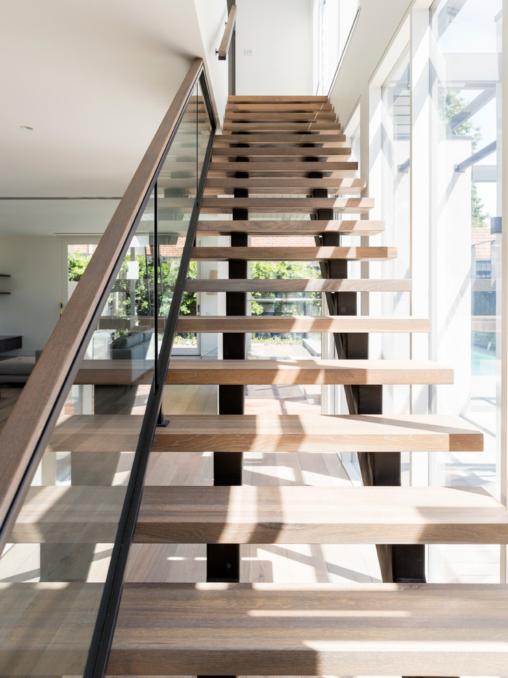 Large modern wood straight staircase in Melbourne with open risers.
