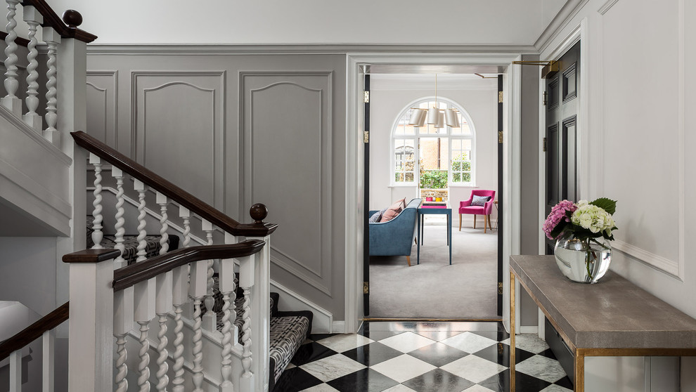 Photo of a large contemporary hallway in London with grey walls, marble floors and multi-coloured floor.