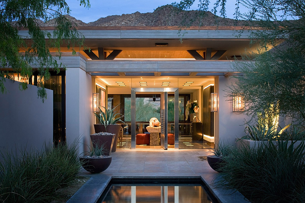 Photo of a contemporary patio in Orange County with a roof extension.