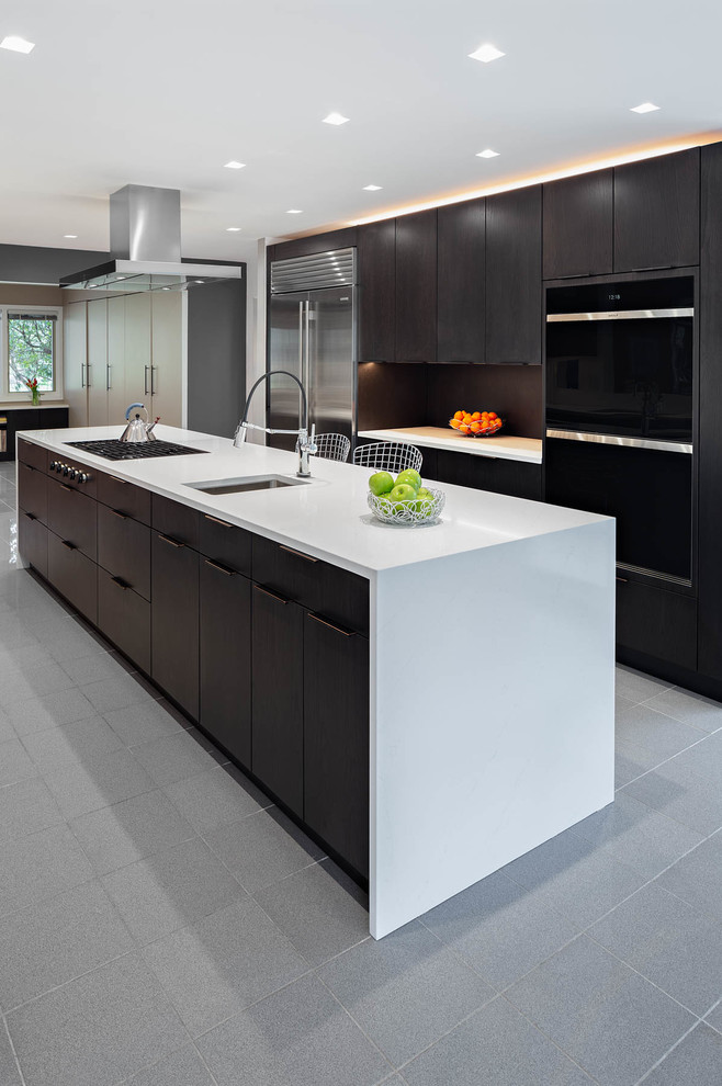 This is an example of a large contemporary u-shaped kitchen in Other with an undermount sink, flat-panel cabinets, brown cabinets, quartz benchtops, brown splashback, stainless steel appliances, marble floors, with island, grey floor and white benchtop.