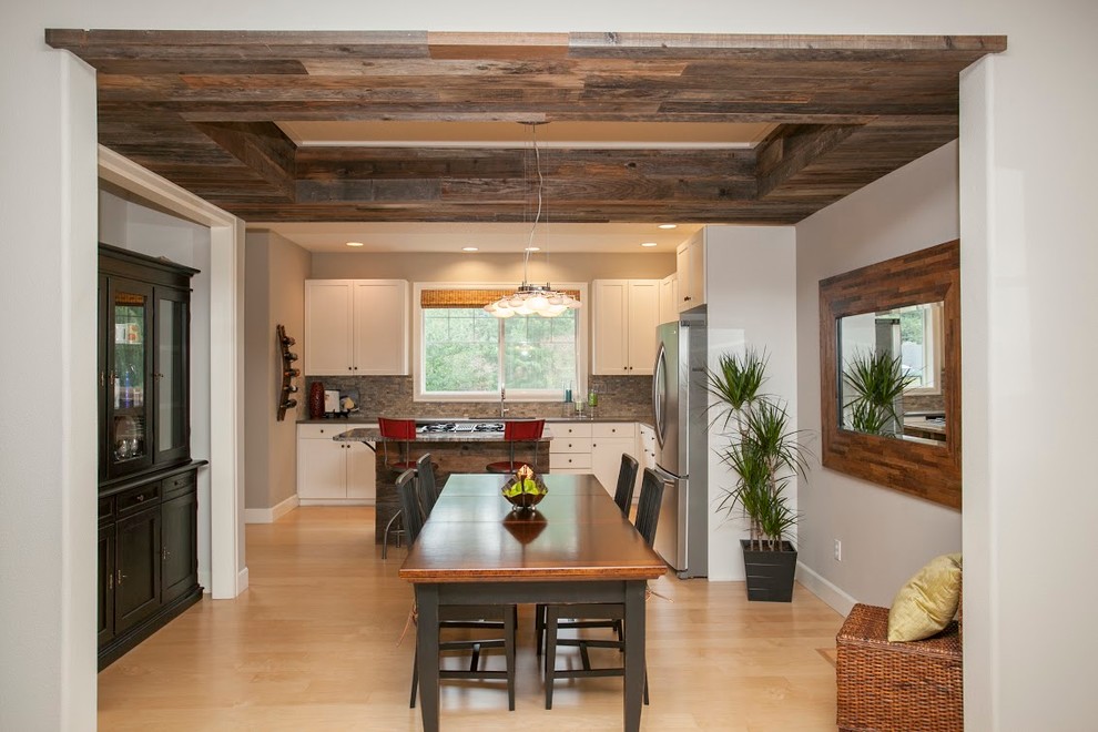 Mid-sized country kitchen/dining combo in Portland with grey walls, light hardwood floors, no fireplace and beige floor.