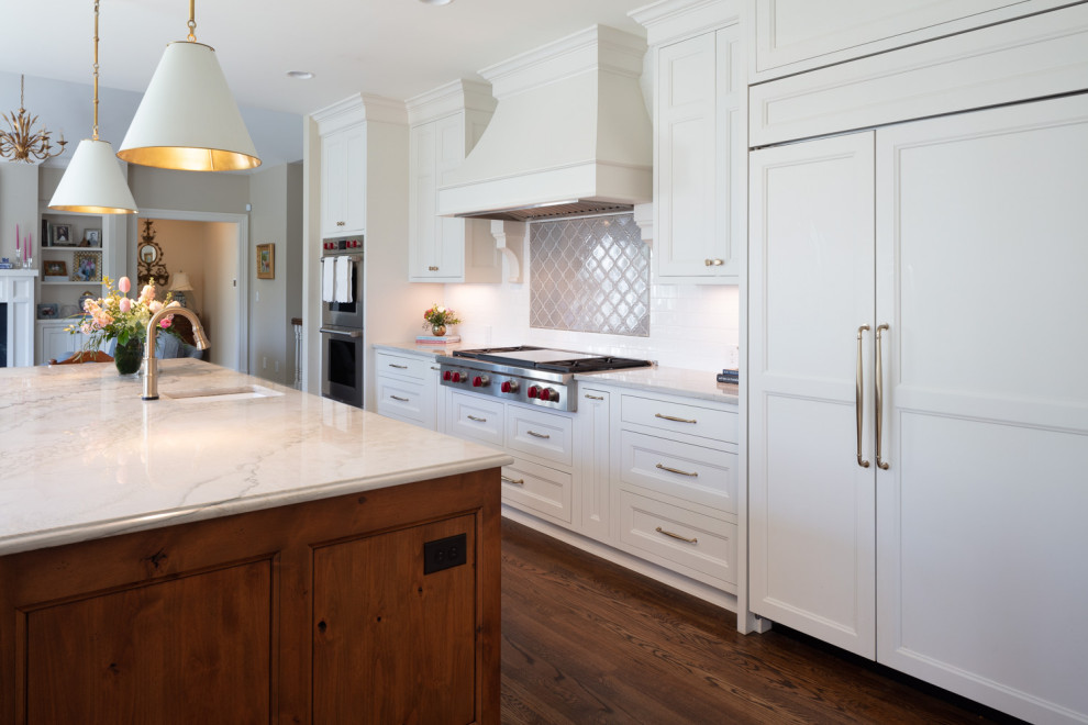 This is an example of a country kitchen in Cincinnati with a farmhouse sink, flat-panel cabinets, white cabinets, grey splashback, ceramic splashback, stainless steel appliances, dark hardwood floors, with island, brown floor and yellow benchtop.