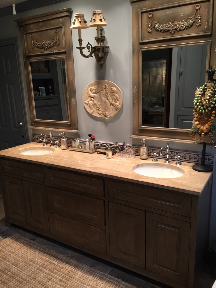 Inspiration for a large master bathroom in Dallas with an undermount sink, furniture-like cabinets, blue cabinets, a claw-foot tub, a corner shower, a two-piece toilet, beige tile, stone tile, blue walls and porcelain floors.