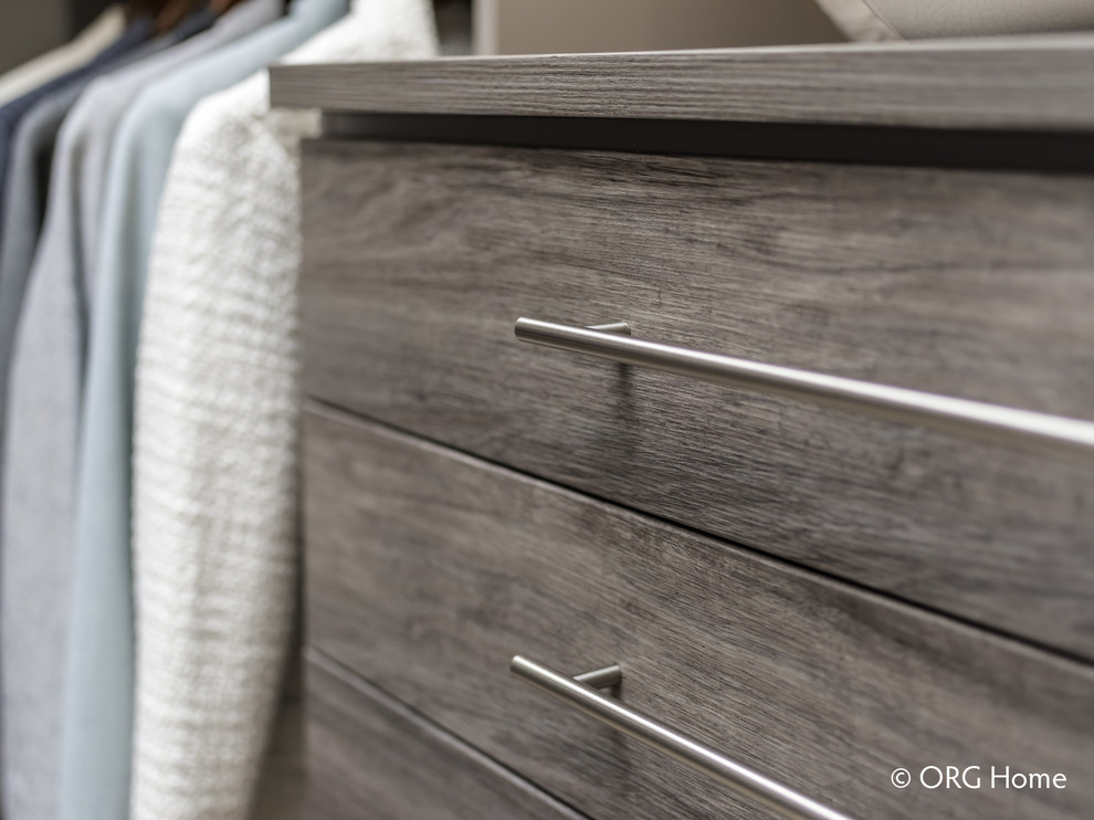 Inspiration for a mid-sized transitional gender-neutral carpeted and beige floor walk-in closet remodel with flat-panel cabinets and gray cabinets