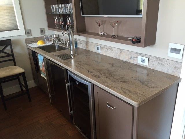 Mid-sized traditional single-wall wet bar in Chicago with an undermount sink, solid surface benchtops, open cabinets, brown splashback, dark hardwood floors, brown floor and brown cabinets.