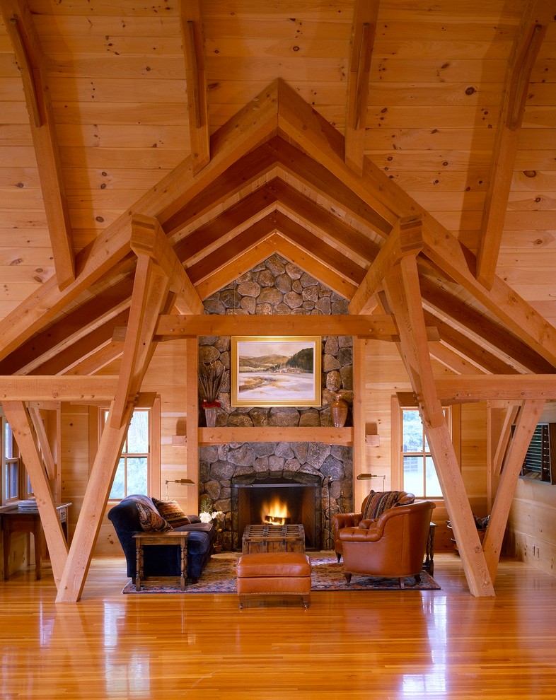 Photo of a country living room in Boston with medium hardwood floors and a stone fireplace surround.