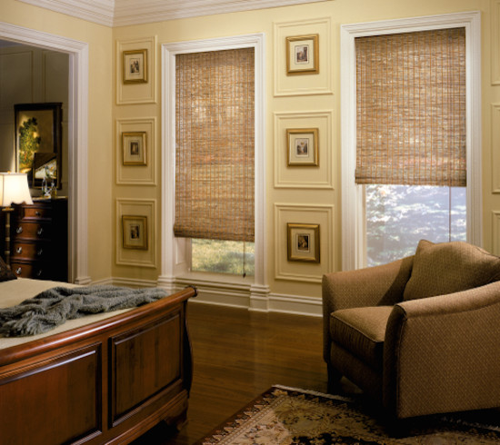 Inspiration for a traditional master bedroom in Jackson with yellow walls, medium hardwood floors and no fireplace.