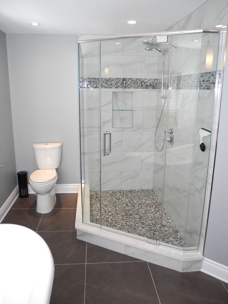 Photo of a mid-sized contemporary master bathroom in Ottawa with an integrated sink, beaded inset cabinets, dark wood cabinets, a freestanding tub, a corner shower, a one-piece toilet, gray tile, glass tile, grey walls and ceramic floors.