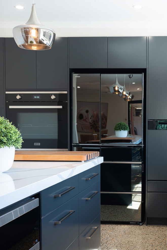 Mid-sized contemporary l-shaped eat-in kitchen in Brisbane with black cabinets, quartz benchtops, black appliances, concrete floors, with island and grey floor.