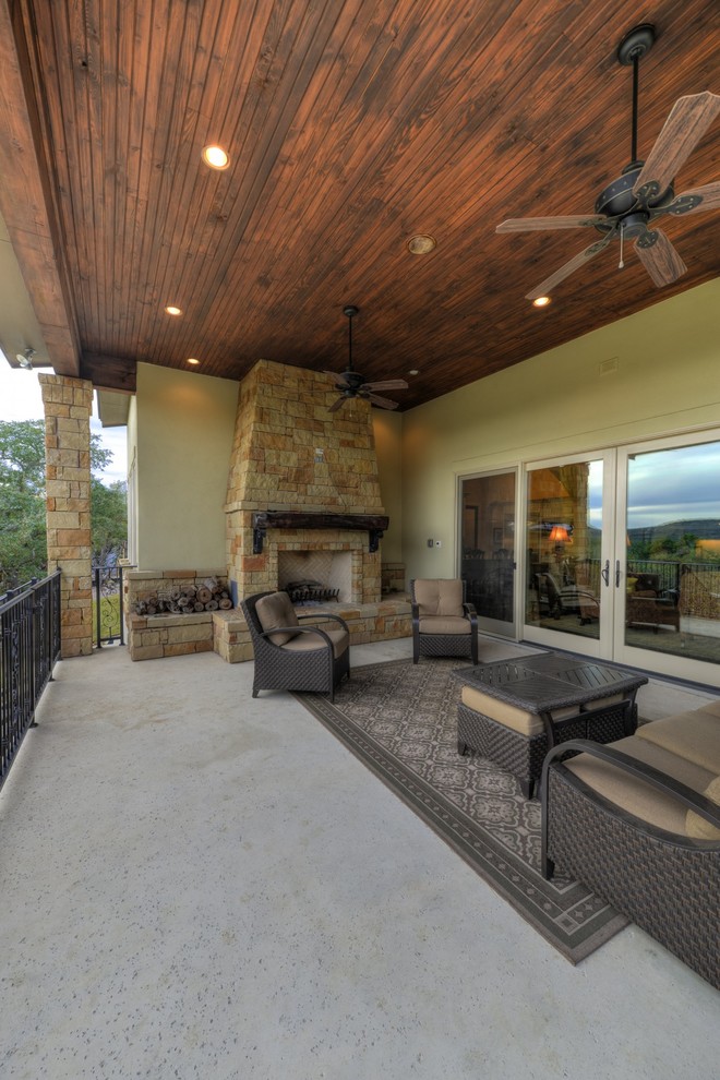 This is an example of a large transitional patio in Albuquerque with a fire feature and a roof extension.