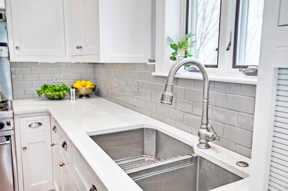 Inspiration for a mid-sized transitional l-shaped light wood floor and beige floor kitchen remodel in Chicago with an undermount sink, shaker cabinets, white cabinets, quartzite countertops, gray backsplash, subway tile backsplash, stainless steel appliances and an island