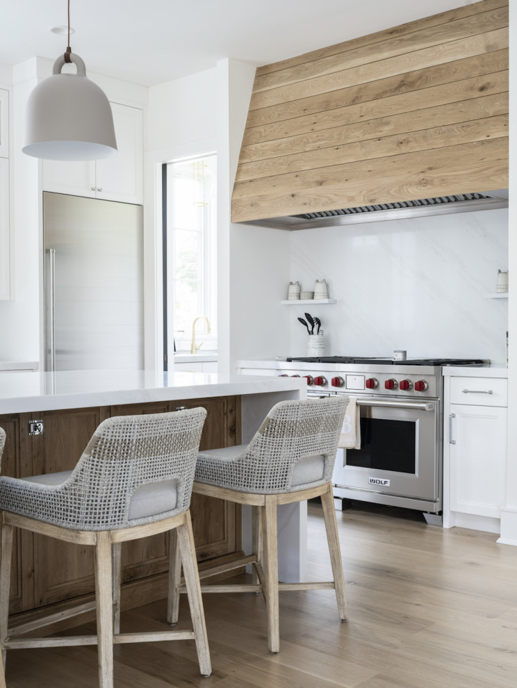 Exempel på ett mycket stort modernt vit vitt kök, med en rustik diskho, skåp i shakerstil, vita skåp, bänkskiva i kvarts, vitt stänkskydd, stänkskydd i marmor, rostfria vitvaror, ljust trägolv, en köksö och brunt golv