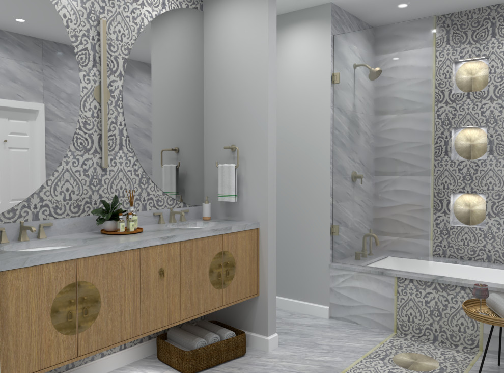 Photo of a small transitional master bathroom with flat-panel cabinets, medium wood cabinets, an undermount tub, a shower/bathtub combo, gray tile, marble, grey walls, marble floors, an undermount sink, quartzite benchtops, grey floor, a hinged shower door and grey benchtops.