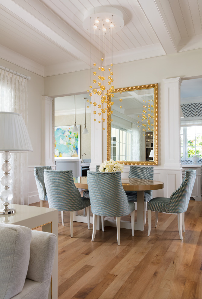 This is an example of a medium sized beach style open plan dining room in Miami with beige walls, medium hardwood flooring, brown floors, a coffered ceiling and panelled walls.