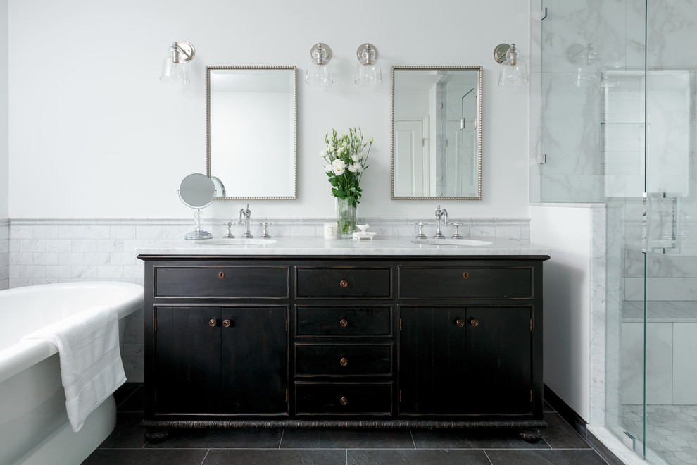 Inspiration for a traditional master bathroom in Vancouver with dark wood cabinets, a freestanding tub, gray tile, marble, white walls, an undermount sink, marble benchtops, grey floor, a hinged shower door, grey benchtops and flat-panel cabinets.