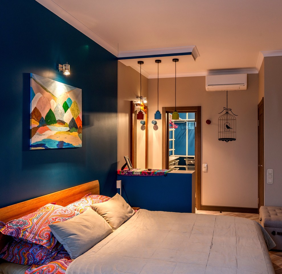 This is an example of a small contemporary master bedroom in Moscow with blue walls, cork floors and brown floor.