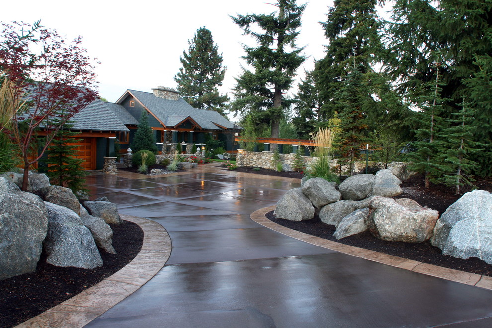 Inspiration for a large traditional front yard driveway in Seattle with natural stone pavers.