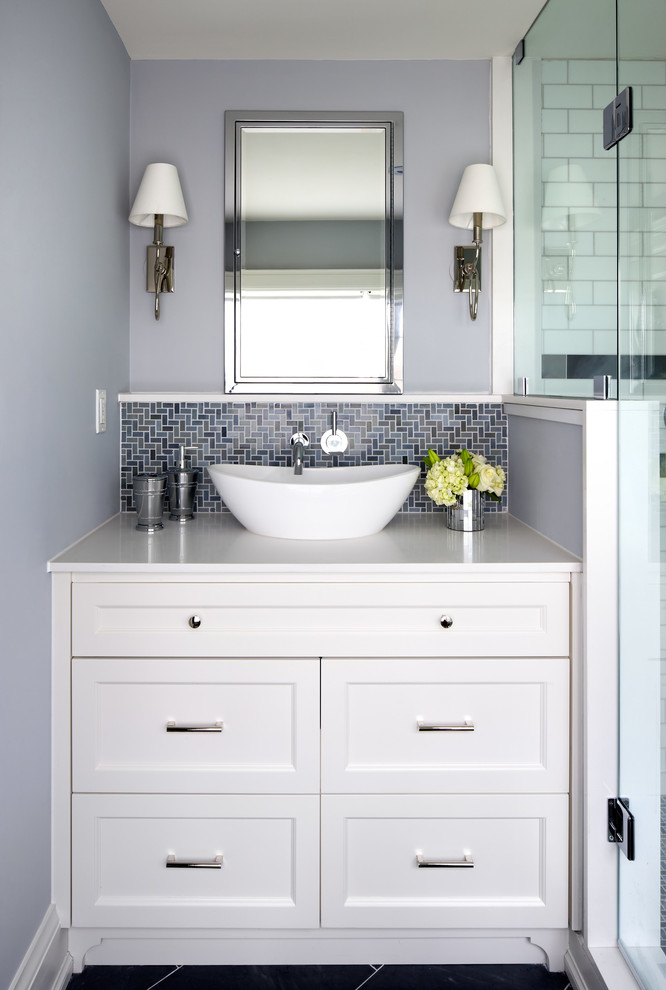 This is an example of a transitional bathroom in Toronto with white cabinets and blue tile.