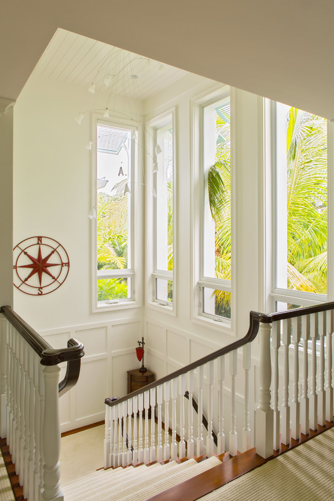 Inspiration for an expansive transitional wood u-shaped staircase in Miami with painted wood risers.