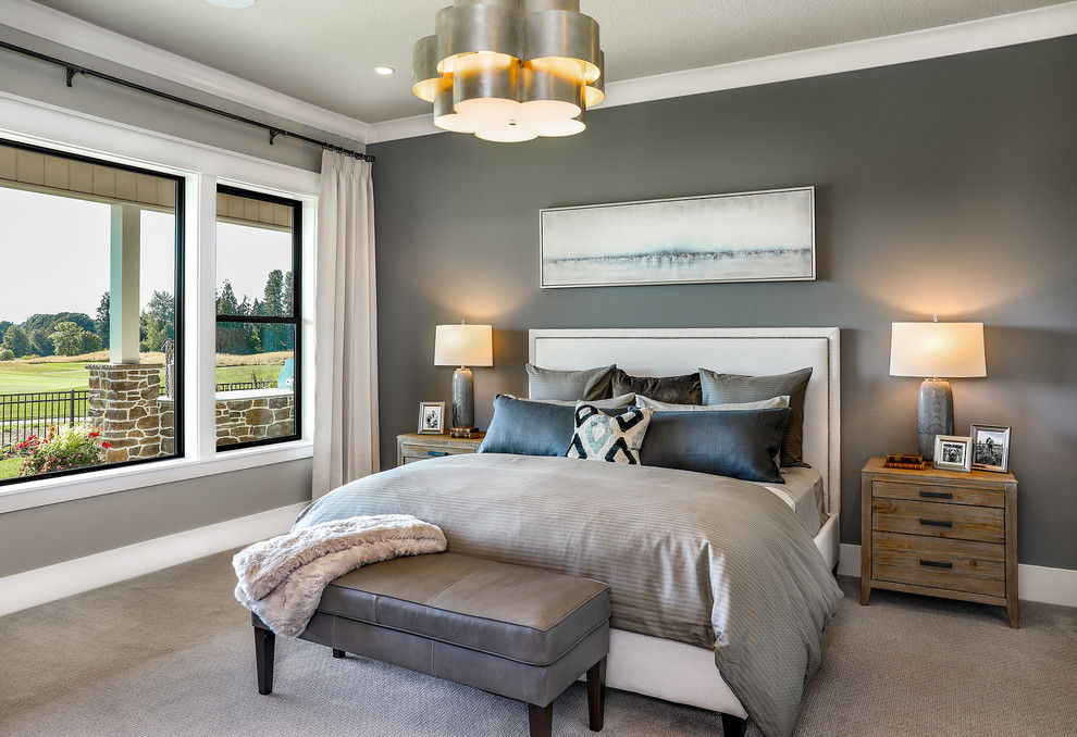 This is an example of a large country master bedroom in Portland with blue walls, carpet and beige floor.