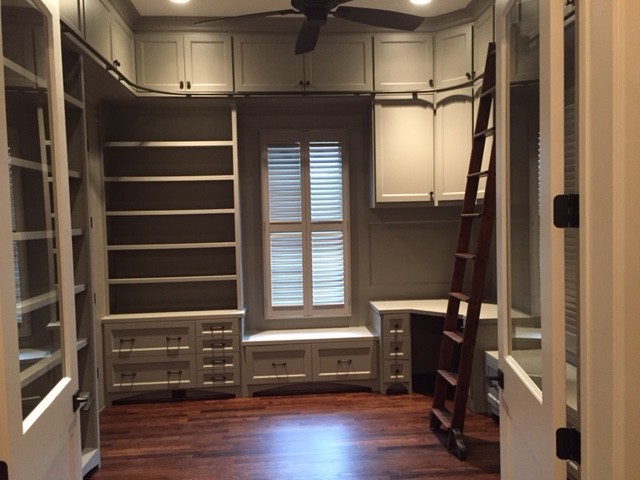 This is an example of a transitional storage and wardrobe in Houston.