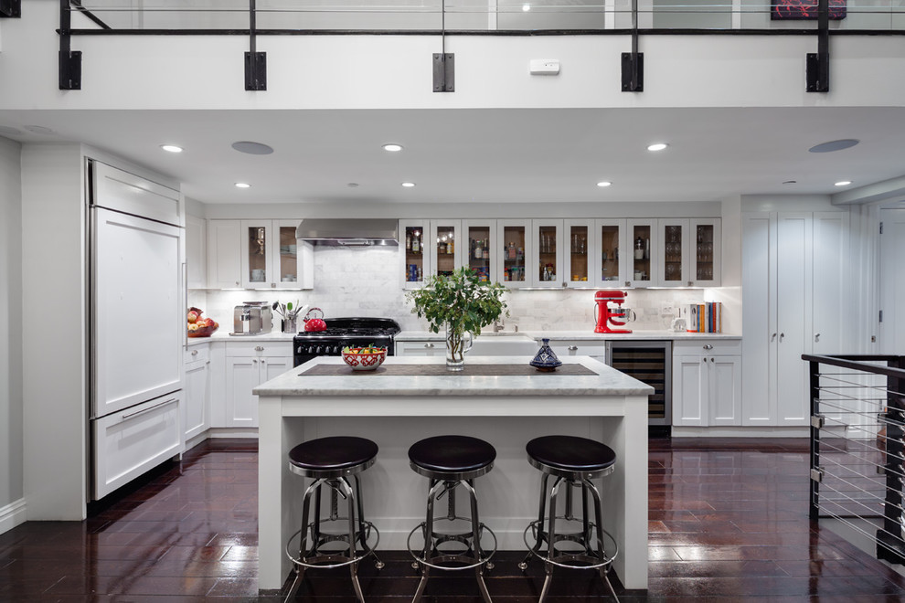 Photo of a contemporary l-shaped kitchen in New York with glass-front cabinets, white splashback, panelled appliances, dark hardwood floors and with island.