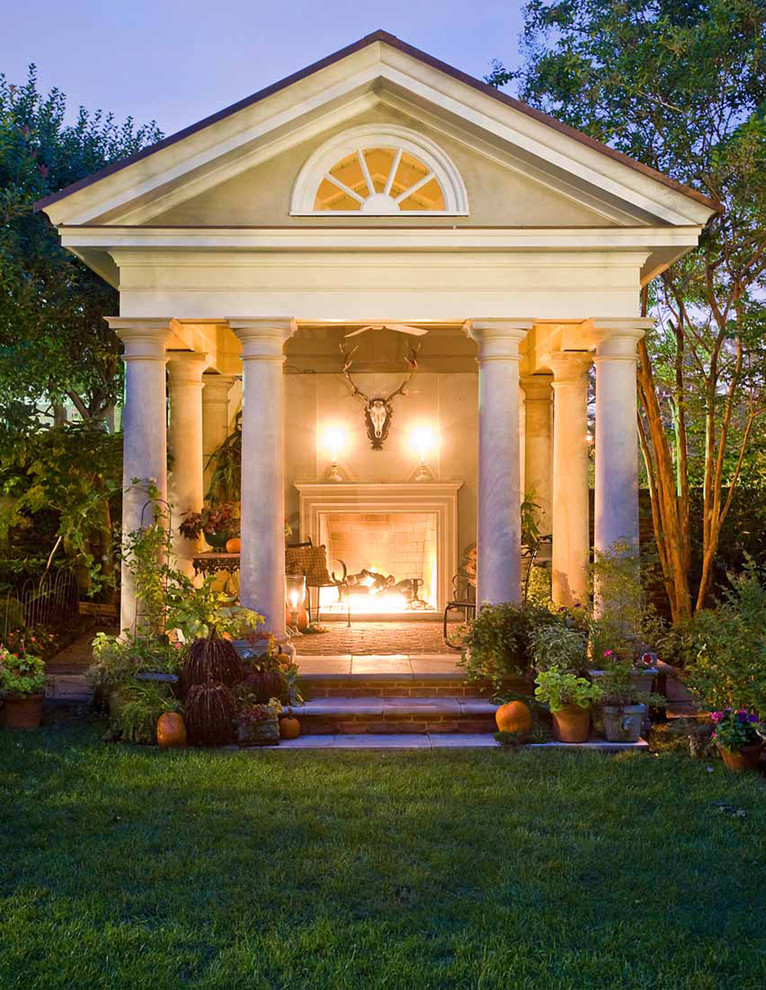 Design ideas for a traditional backyard patio in DC Metro with brick pavers, a gazebo/cabana and with fireplace.