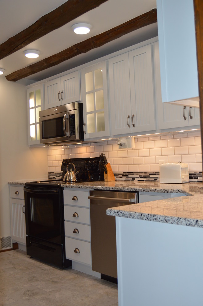 Eat-in kitchen - small transitional l-shaped porcelain tile eat-in kitchen idea with an undermount sink, flat-panel cabinets, gray cabinets, granite countertops, white backsplash, subway tile backsplash and stainless steel appliances