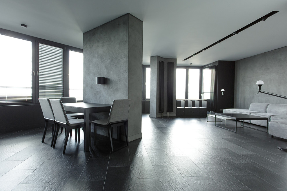 Стильный дизайн: открытая гостиная комната среднего размера в стиле лофт с серыми стенами и полом из керамогранита - последний тренд
