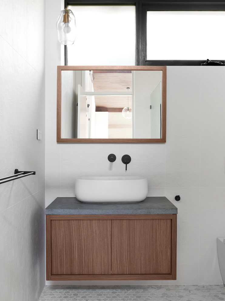 Inspiration for a large midcentury kids bathroom in Sydney with flat-panel cabinets, dark wood cabinets, a japanese tub, a double shower, a one-piece toilet, white tile, ceramic tile, white walls, marble floors, a vessel sink, engineered quartz benchtops, grey floor, an open shower and grey benchtops.