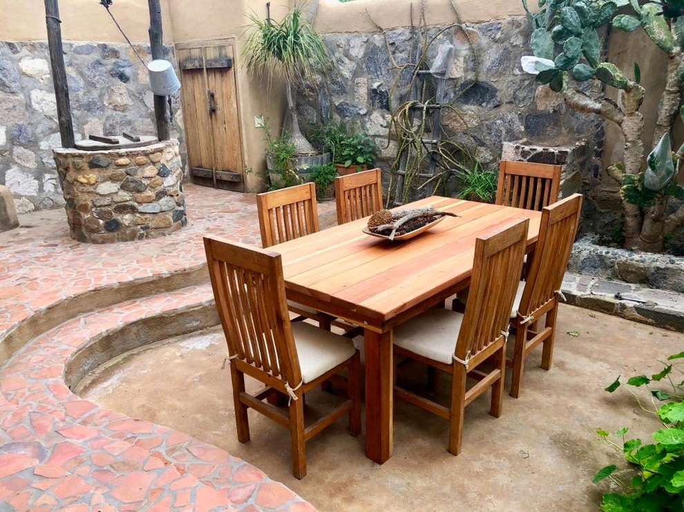 Photo of a large backyard patio in San Diego with natural stone pavers and no cover.