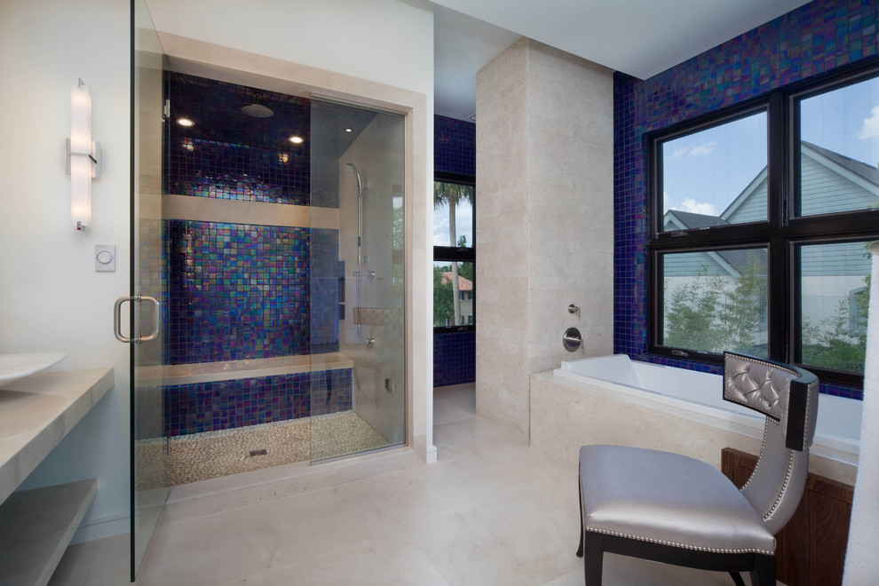 Inspiration for a contemporary bathroom in Orlando with a drop-in tub, blue tile, mosaic tile and beige floor.